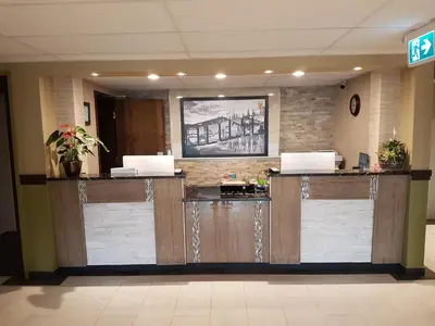a lobby with a reception desk with two laptops on it at Super 8 by Wyndham Hardisty in Hardisty