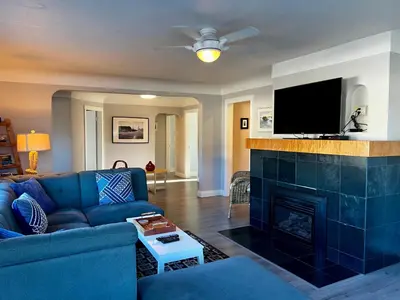 a living room with a blue couch and a fireplace at Buccaneer Inn in Nanaimo