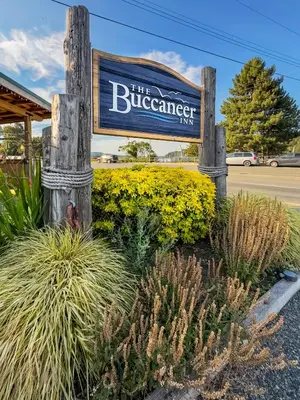 a sign for the bluerenser inn next to some plants at Buccaneer Inn in Nanaimo
