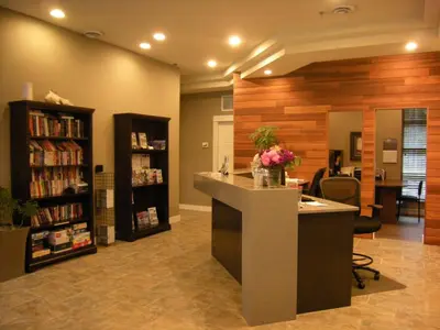 a lobby with a library with a desk and books at Oceanside Village Resort in Parksville