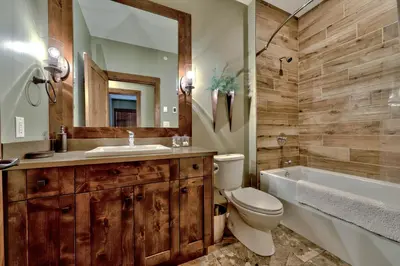 a bathroom with a toilet and a sink and a tub at 17 Village Walk Sun Peaks BC in Sun Peaks