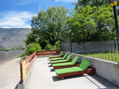 a row of green chairs sitting on a wall at Falcon Resort in Osoyoos