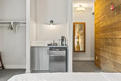 a kitchen with a stainless steel dishwasher next to a counter at Basecamp Lodge Canmore in Canmore
