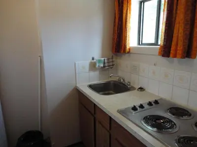 a small kitchen with a sink and a window at Spanish Fiesta Resort in Osoyoos