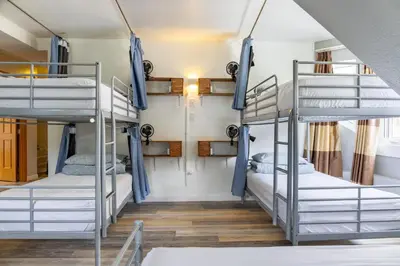a room with three bunk beds in a hostel at Samesun Banff Hostel in Banff