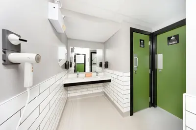 a bathroom with a sink and a mirror at Samesun Vancouver in Vancouver
