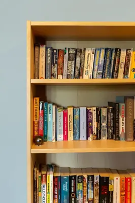 a book shelf filled with lots of books at HI Kelowna Hostel in Kelowna