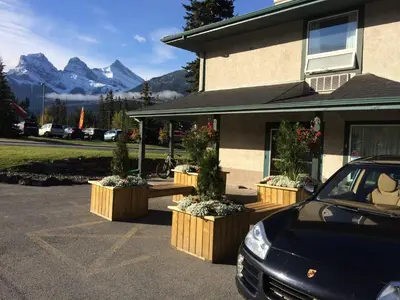 a car parked in a parking lot next to a building at Mountain View Inn in Canmore