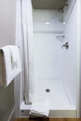 a bathroom with a shower with a shower curtain at Gage Suites at UBC in Vancouver