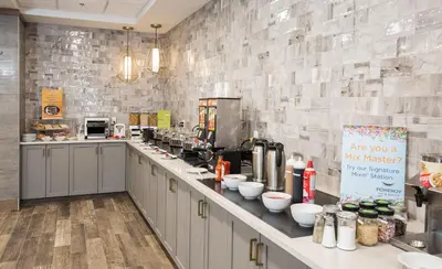 a large kitchen with a counter with a counter top at Pomeroy Inn & Suites Prince George in Prince George
