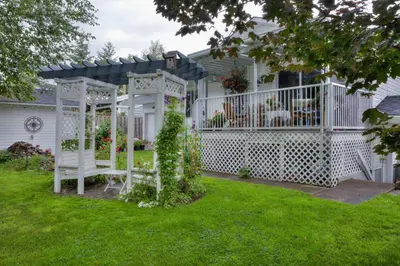 a white gazebo in the yard of a house at Hummingbird Bed and Breakfast in Clearwater