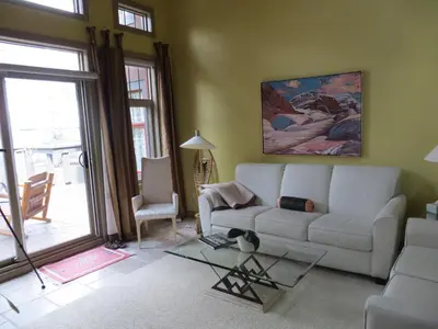 a living room with a white couch and a table at Buffaloberry Bed & Breakfast in Banff