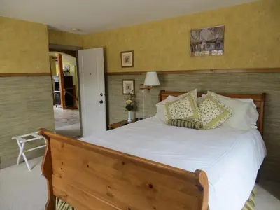 a bedroom with a bed with white sheets and pillows at Buffaloberry Bed & Breakfast in Banff