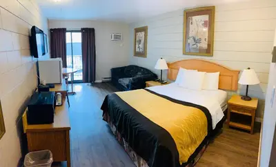 a hotel room with a bed and a television at Armstrong Inn in Armstrong