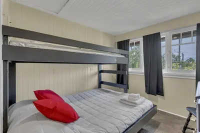 a bedroom with a bunk bed with a red pillow at HI Penticton - Hostel in Penticton
