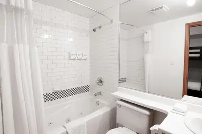 a bathroom with a tub and a toilet and a sink at Alpenglow Lodge by MVA in Whistler