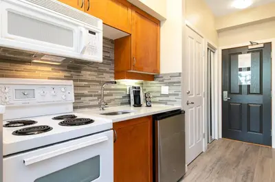 a kitchen with a white stove and a sink at Alpenglow Lodge by MVA in Whistler