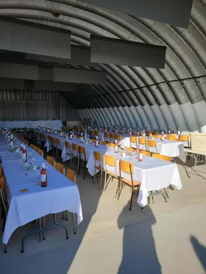 a group of tables and chairs in a large room at The Ranch Highway 55 in Debden