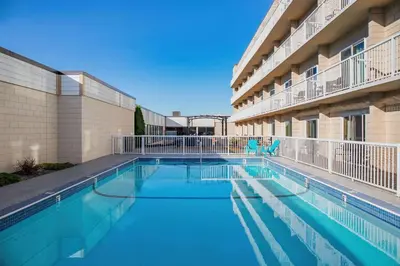 a swimming pool in front of a building at Days Inn by Wyndham Cranbrook Conference Centre in Cranbrook