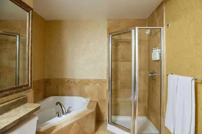 a bathroom with a bath tub and a shower at Days Inn by Wyndham Cranbrook Conference Centre in Cranbrook