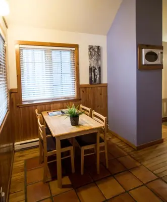 a dining room with a table and chairs at Reef Point Cottages in Ucluelet