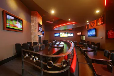 a dining room with tables and chairs and televisions at Century Casino & Hotel Edmonton in Edmonton