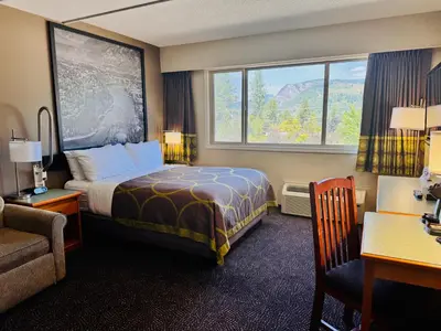 a hotel room with a bed and a window at Super 8 by Wyndham Castlegar BC in Castlegar