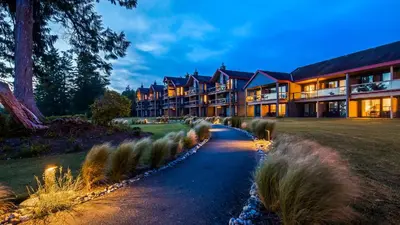 a large building with a pathway in front of it at Best Western Plus Tin Wis Resort in Tofino