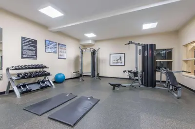 a gym with treadmills and weights in a room at Ramada by Wyndham Wainwright in Wainwright