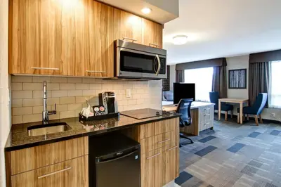 a kitchen with a sink and a desk in a room at Canalta St.Paul in St. Paul