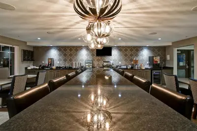 a large bar with a long table and chairs at Canalta St.Paul in St. Paul