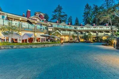 a large building with a courtyard at night at Poets Cove Resort & Spa in Bedwell Harbour