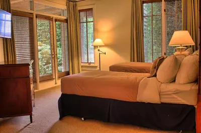 a bedroom with two beds and a flat screen tv at Poets Cove Resort & Spa in Bedwell Harbour