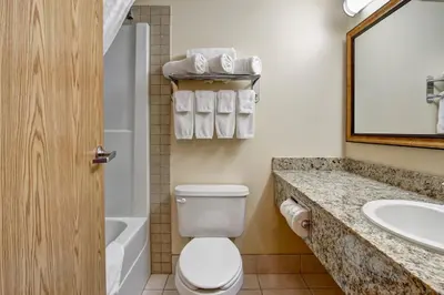 a bathroom with a toilet and a sink at Canalta Rocky Mountain House in Rocky Mountain House
