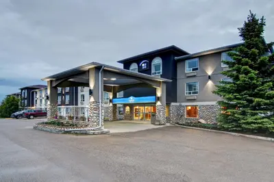 a building with a parking lot in front of it at Canalta Rocky Mountain House in Rocky Mountain House