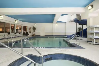 a large swimming pool in a hotel lobby at Travelodge by Wyndham Strathmore in Strathmore