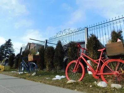 two red bikes parked next to a fence at The Calgary Hub hostel style Home in Calgary