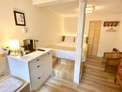 a bedroom with a bed and a desk with a microwave at Richca Chalets Resort in Hope