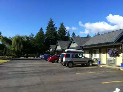 a car parked in a parking lot in front of a building at New Horizon Motel in Christina Lake