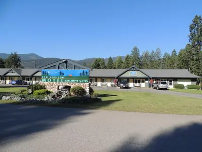 a building with a sign in front of it at New Horizon Motel in Christina Lake