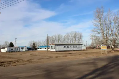 an empty parking lot with a building in the background at Raval Paradise Motel and RV Park in Youngstown