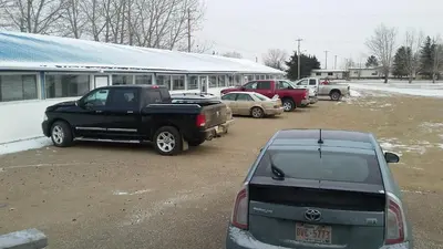 a group of cars parked in a parking lot at Raval Paradise Motel and RV Park in Youngstown