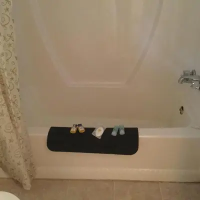 a bath tub with two shoes and a pair ofippers at Raval Paradise Motel and RV Park in Youngstown