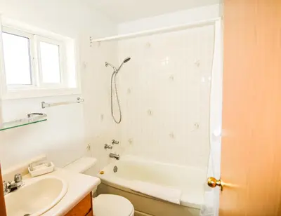 a bathroom with a tub and a sink and a toilet at Shoreline Resort Condominiums in Penticton