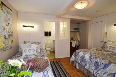 a bedroom with two beds and a bathroom at Marketa's Bed and Breakfast in Victoria