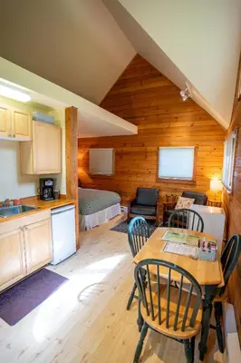 a kitchen and dining room with a table and chairs at Across the Creek Cabins in Clearwater