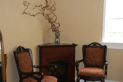 two chairs and a vase sitting next to a fireplace at Nimpkish Hotel in Alert Bay