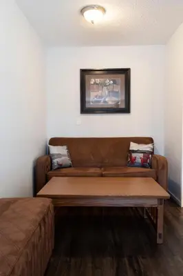 a couch in a living room with at Schott's Lake Conference & Resort in Sundre