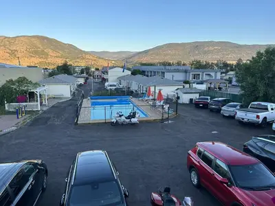 a parking lot with cars parked in a parking lot at 5000 Motel in Penticton