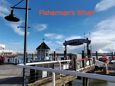 a pier with a sign that reads fishermans wharf at Bed Plus YVR in Richmond